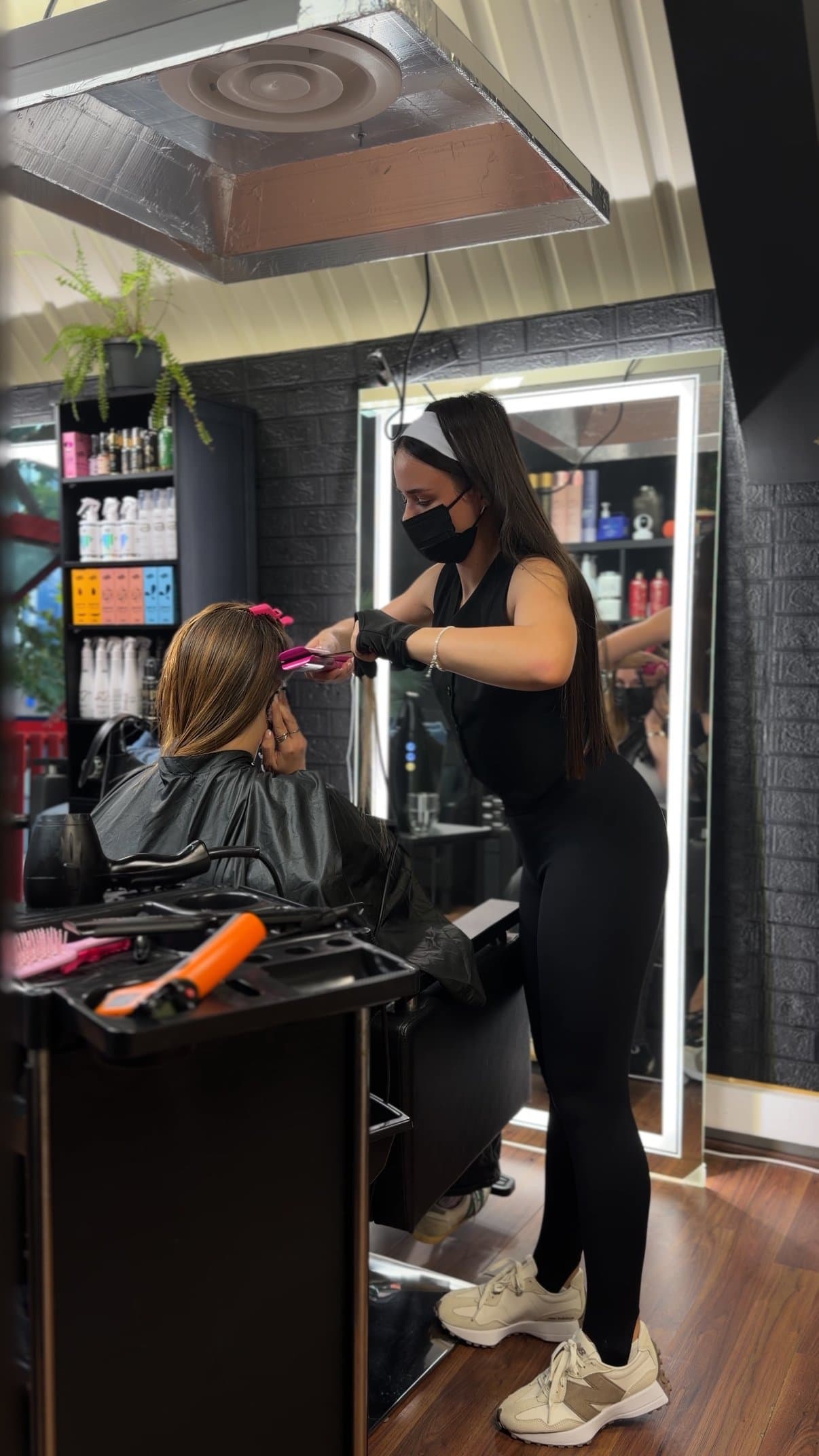 Yelyzaveta straightening hair with iron